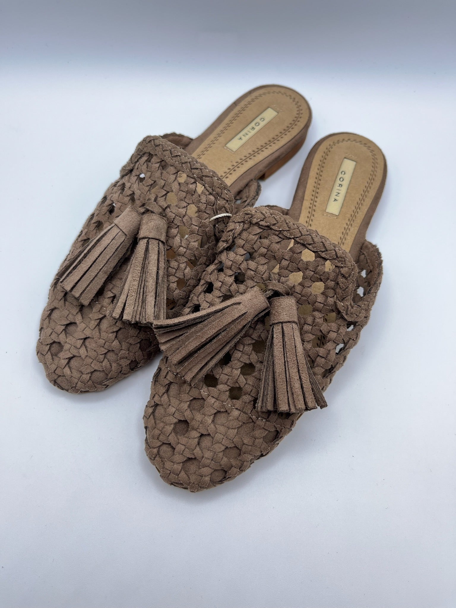 Mules Corina de senhora castanhas Taupe em camurça sintética trançada; sapatos rasos casuais, chinelos com detalhe de borlas franja e biqueira fina para o dia a dia